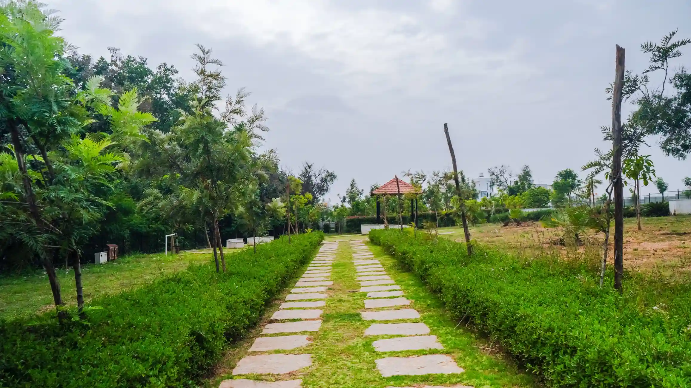 Landscaped park and stone pathway of site for sale in Magadi Road at Shyam Residency